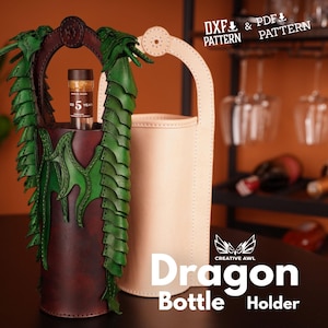 May include: A brown leather bottle holder shaped like a dragon with green scales. The holder is designed to hold a bottle of wine or spirits. The holder is sitting on a table with a white leather bottle holder in the background. The text "Dragon Bottle Holder" is printed on the table in front of the holders.