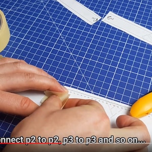 K&ouml;nnte beinhalten: Zwei H&auml;nde kleben zwei St&uuml;cke wei&szlig;es Papier zusammen. Das Papier ist mit Markierungen versehen und der Text "connect p2 to p2, p3 to p3 and so on..." ist am unteren Rand des Bildes sichtbar.