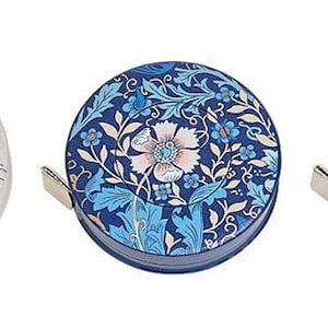 May include: Three decorative tape measures with unique designs. One features bees, another a floral pattern in blue, and the third showcases birds and flowers. Each tape measure has a silver metal pull tab.