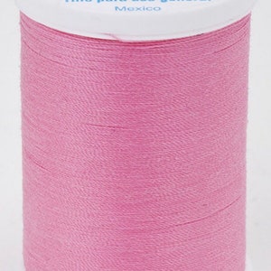 May include: A pink spool of Coats Dual Duty XP All Purpose thread. The spool is labeled with 250 yards (229 meters) and says "Fil Tout Usage" and "Hilo para uso general".