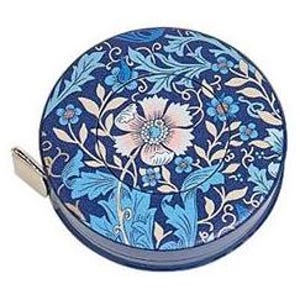 May include: A round, navy blue tape measure with a floral design in shades of blue, pink, and cream. The design features stylized flowers and leaves. A small, silver metal tab extends from the side.