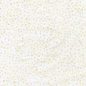 May include: Off-white fabric with a pattern of small, irregularly shaped, light-yellow dots scattered across the surface. The dots vary in size and density, creating a textured appearance. The fabric has a slightly wrinkled texture.