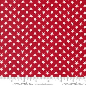 May include: Red fabric with a white star pattern. The stars are small and evenly spaced.