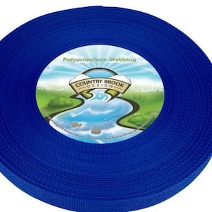 May include: A roll of bright blue polypropylene webbing. The center of the roll features a circular label with the text "Polypropylene Webbing" and the "Country Brook Design" logo, depicting a river scene.