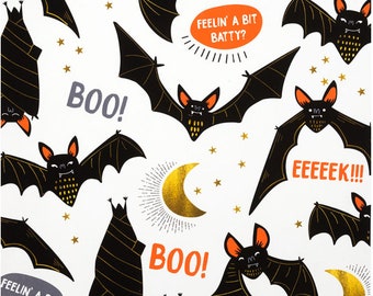 May include: A white background with black bats and gold crescent moons. The bats have orange eyes and mouths. The text "BOO!" and "FEELIN' A BIT BATTY?" is written in orange and black.