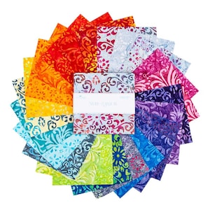 May include: A circular arrangement of colorful fabric squares in a rainbow of hues, from red to purple, with a white label in the center. Each square features a patterned design. The label reads "Swirl Rainbow".