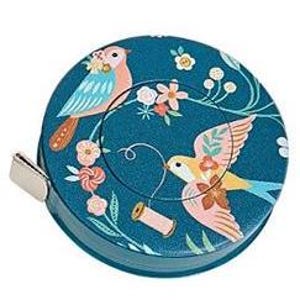 May include: A teal tape measure with a decorative bird and floral design. The tape measure features two birds, one perched and one in flight, surrounded by flowers and vines. A small metal tab is visible on the side.
