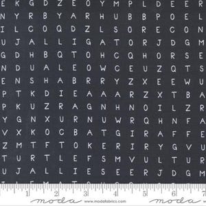 May include: Black and white fabric with a repeating pattern of letters. The letters are arranged in a grid pattern and are all uppercase. The fabric is a dark grey color and the letters are white.