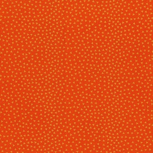 May include: A red fabric with a repeating pattern of small orange triangles.