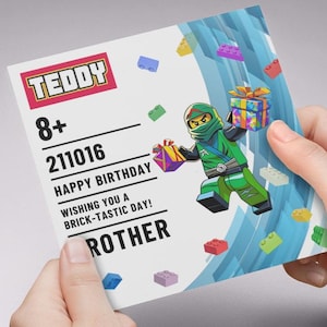 May include: A birthday card with a Lego-style ninja character in green and black, holding gifts. The card features the word "TEDDY" in a red and white box, age 8+, and the text "HAPPY BIRTHDAY" and "WISHING YOU A BRICK-TASTIC DAY!" for "ROTHER".