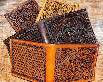 May include: Three leather wallets with different embossed designs. The top wallet has a floral design, the middle wallet has a woven pattern, and the bottom wallet has a floral design.