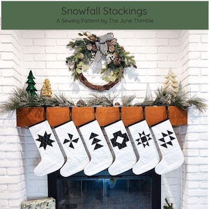 May include: White Christmas stockings with black geometric patterns hang above a fireplace, adorned with a wreath and greenery. The text "Snowfall Stockings" and "A Sewing Pattern by The June Thimble" are visible. The difficulty level is intermediate.