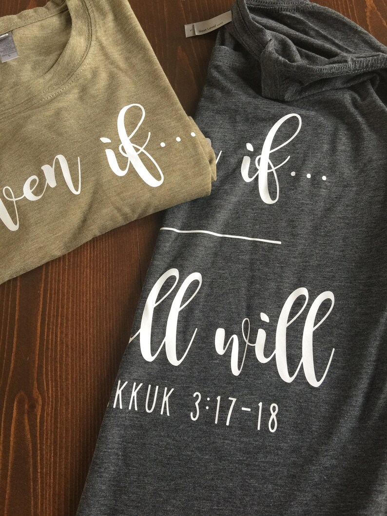 May include: Two t-shirts with the phrase "Even if... all will" printed on them. The top shirt is a light brown color and the bottom shirt is a dark gray color. The text is in white and the bottom shirt also has the text "KKUK 3:17-18" printed on it.