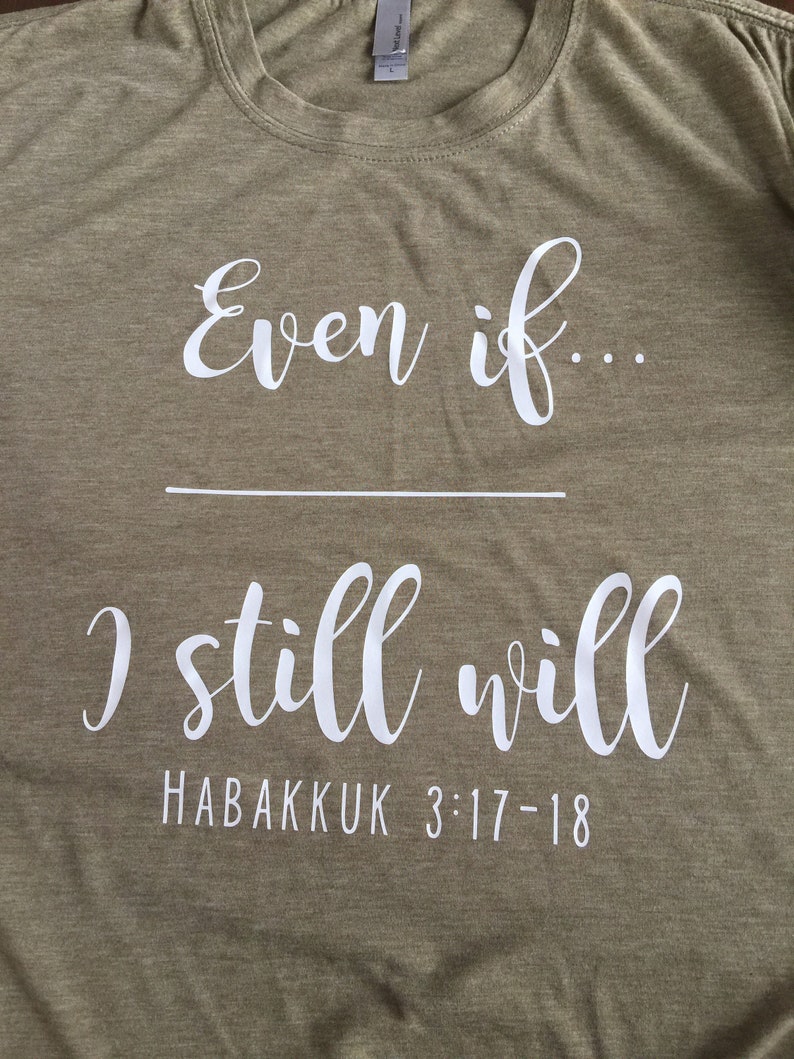 May include: A green t-shirt with white text that reads "Even if... I still will" and "Habakkuk 3:17-18".