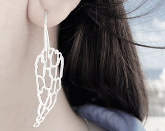 Playful long silver earrings in angel wings design and minimal style