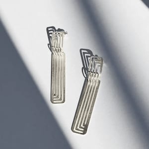 Minimal long silver earrings in architectural and geometric Art Deco design
