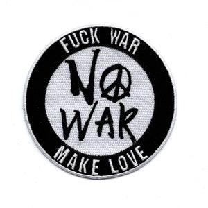 May include: Black and white embroidered patch with the text "FUCK WAR NO WAR MAKE LOVE" and a peace sign.