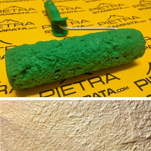 May include: A green paint roller with a textured surface. The roller is designed to create a stone-like effect on walls.