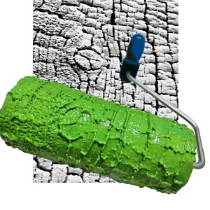 May include: A green paint roller with a textured surface, designed to create a wood grain effect. The roller is partially covering a white and black background.