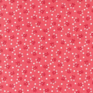 May include: A pink fabric with a white floral pattern. The fabric is covered in small white stars and red floral sprigs.