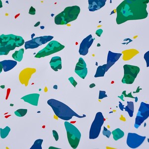 May include: Abstract pattern with blue, green, yellow, and red splotches on a white background.