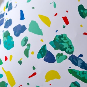May include: White background with a scattered pattern of blue, green, yellow, and red irregular shapes.