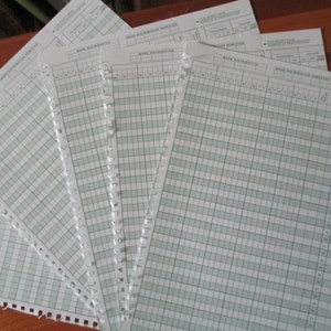 May include: A stack of white paper forms with a grid pattern and the text "Mark Distribution Semester" printed at the top. The forms are used for recording student grades.