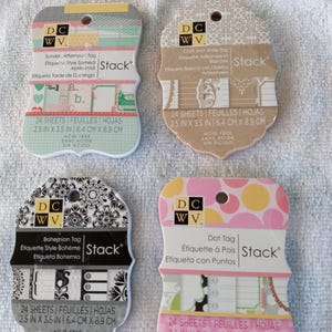 May include: Four decorative paper tag sets with various designs. Each tag set includes 24 sheets and measures 2.5 x 3.5 inches. The tags feature patterns like polka dots, floral, and geometric designs.