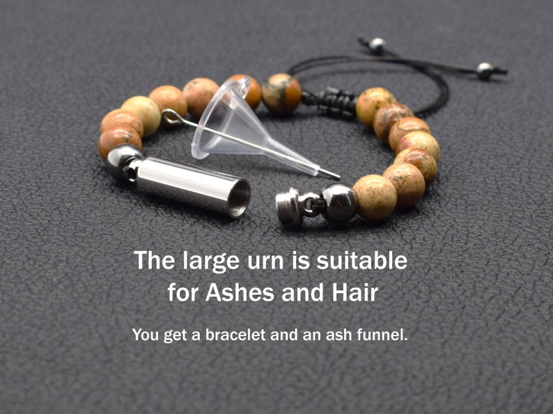 May include: A beaded bracelet with a small metal urn attached. The urn is open and a clear plastic funnel is next to it. The text "The large urn is suitable for Ashes and Hair. You get a bracelet and an ash funnel." is below the image.