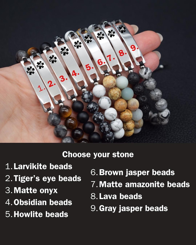 May include: Nine medical alert bracelets featuring silver-tone metal plates with a black Star of Life symbol. Each bracelet has a unique stone bead strand: larvikite, tiger's eye, matte onyx, obsidian, howlite, brown jasper, amazonite, lava, and gray jasper.
