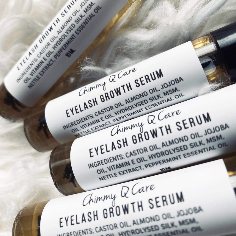 May include: Four glass bottles with white labels that read "Chimmy Q Care Eyelash Growth Serum". The labels list the ingredients: castor oil, almond oil, jojoba oil, vitamin E oil, hydrolysed silk, MSM, nettle extract, and peppermint essential oil.