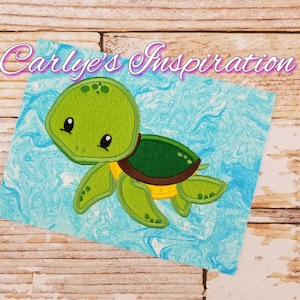 May include: A green and yellow cartoon turtle with a brown shell, swimming in a blue and white marbled background. The turtle has a cute face with big eyes and a small mouth. The image is titled "Carlye's Inspiration".