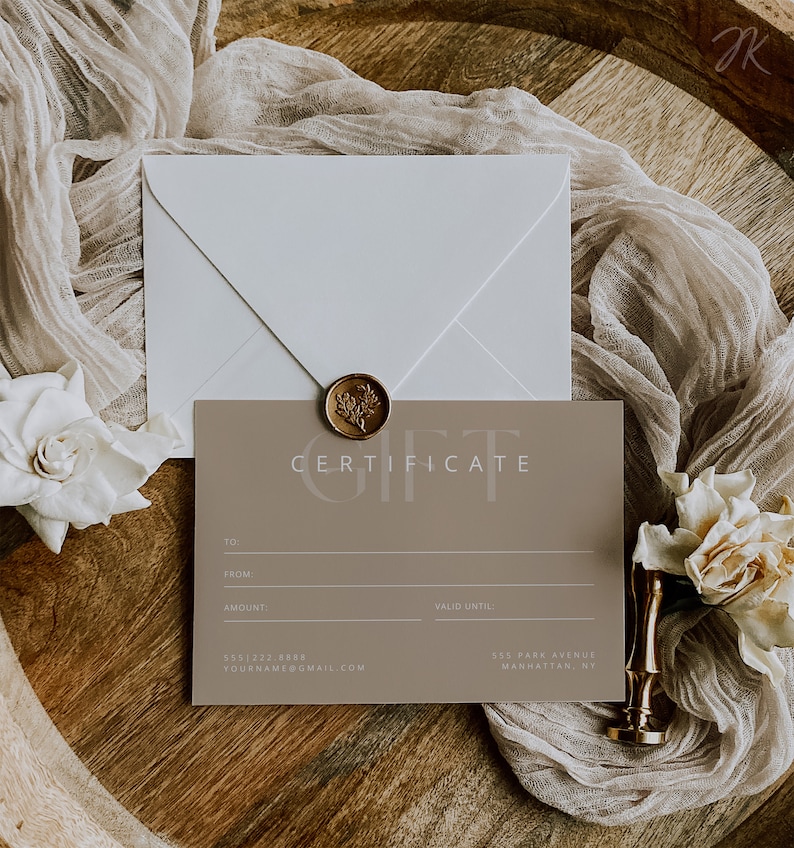 May include: A gift certificate with the word "CERTIFICATE" printed on it, a white envelope, and a gold wax seal. The certificate is taupe with lines for "TO:", "FROM:", "AMOUNT:", and "VALID UNTIL:" and contact information.