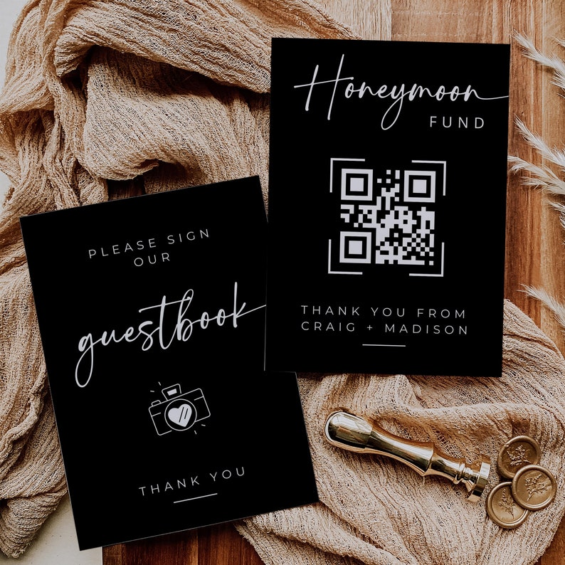 May include: Two black cards with white text. The top card says "Honeymoon Fund" and has a QR code. The bottom card says "Please sign our guestbook" and has a camera icon with a heart.