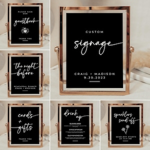 May include: Set of six black and white wedding signs with gold frames. The signs include "Please sign our guestbook", "The night before", "Cards + Gifts", "Drink Up", "Custom Signage", and "Sparklers Send Off".