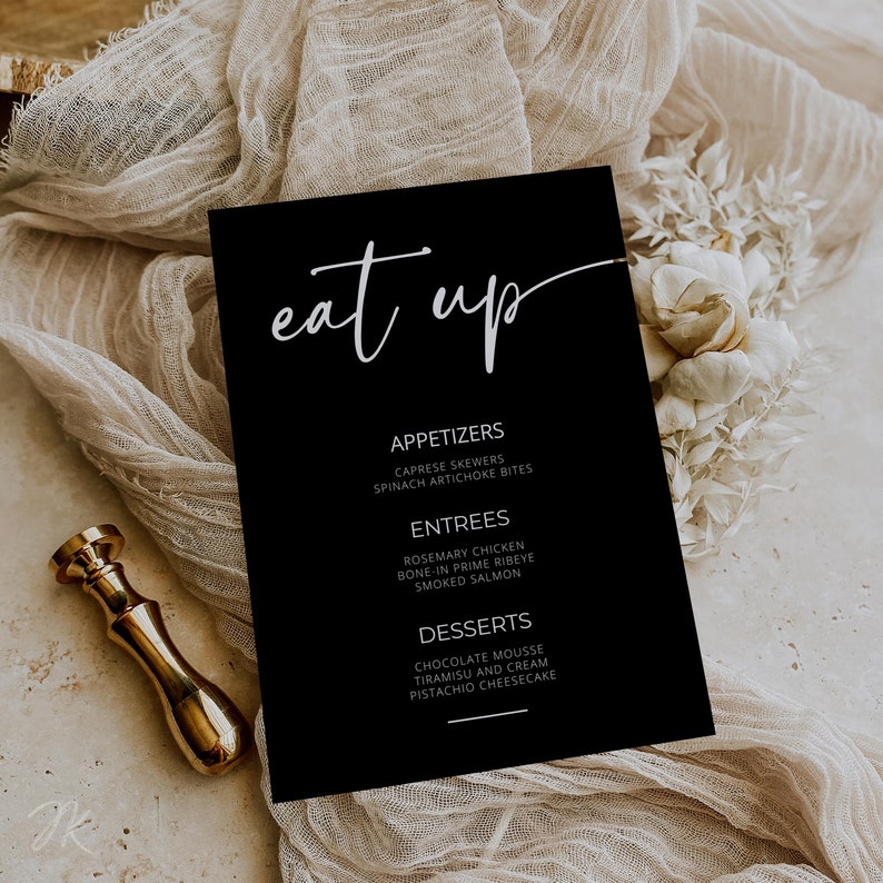 May include: Black and white menu card with the text "eat up" in a handwritten font. The menu lists appetizers, entrees, and desserts.