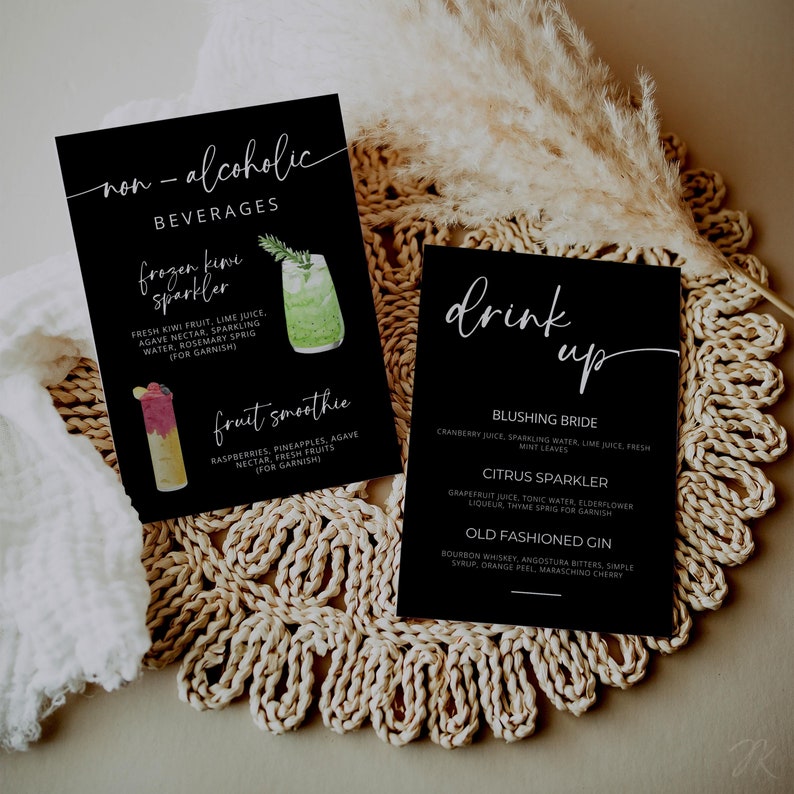 May include: Two black cards with white text and watercolor illustrations of drinks. The first card lists non-alcoholic beverages: "Frozen Kiwi Sparkler" and "Fruit Smoothie". The second card lists alcoholic beverages: "Blushing Bride", "Citrus Sparkler", and "Old Fashioned Gin".