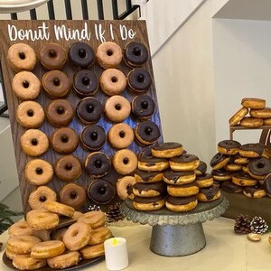 Our Donut walls are sure to be a hit at your next party or event! Each one comes with a stand on the back and has a variety of color choices. It has 30 pegs, and they can be short, that hold 1 donut per peg or long, that hold 2 donuts peg.