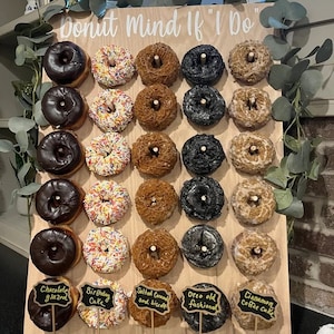 Our Donut walls are sure to be a hit at your next party or event! Each one comes with a stand on the back and has a variety of color choices. It has 30 pegs, and they can be short, that hold 1 donut per peg or long, that hold 2 donuts peg.