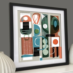 May include: Abstract art print featuring geometric shapes in shades of green, blue, red, and black on a light grey background. The print is framed in black.