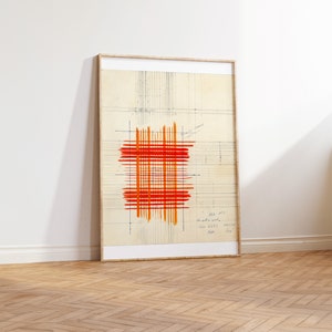 May include: A framed abstract art print with a red and orange grid pattern on a beige background. The print has a grid pattern and handwritten text in the bottom right corner.