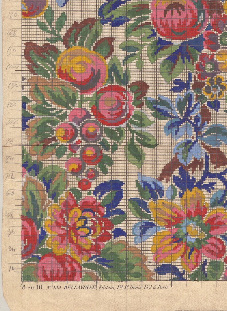 May include: A vintage cross-stitch pattern featuring a floral design with pink, red, yellow, blue, and green flowers. The pattern is on a grid with numbers along the side for reference.