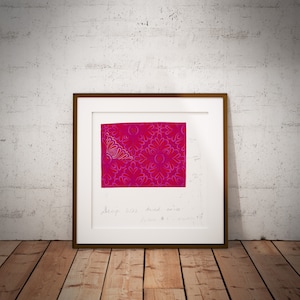 May include: A framed print of a pink and red abstract design with a white border. The print is signed "Serip 603, Aurel 2015, Pieces 8/30".
