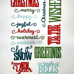 May include: A set of 12 Christmas and New Year themed die cuts. The die cuts are in various colors, including red, green, blue, and white. The die cuts feature phrases like "Christmas", "Merry", "Happy", "Joyful", "Holiday", "Warmest Seasons", "Let it Snow", "Greetings", "Jingle Bells", and "Happy New Year".