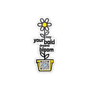 May include: Black and white sticker with a flower growing out of a pot. The flower has a yellow center and the text "may your bold dreams bloom" is written on the sticker.