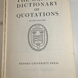 May include: Open book displaying the title "The Oxford Dictionary of Quotations" in black text on an off-white page. The second edition is noted below the title, with the Oxford University Press logo and text at the bottom.