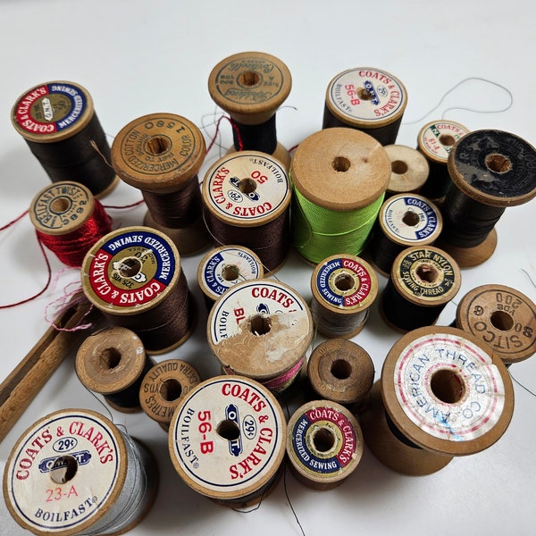 vtg lot 24 wooden thread spools // height range is 1 - 2 inches // various ages, brands, wood color // some with thread