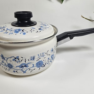 May include: White enamel saucepan with a black handle and a blue and white floral pattern.