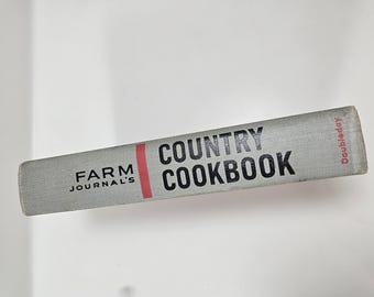 May include: A gray cookbook titled "Farm Journal's Country Cookbook" with black text and a red vertical stripe. The book's spine is visible, with the publisher's name, Doubleday, printed in red.