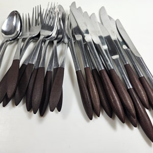 May include: A set of silverware with brown handles. The set includes forks, knives, and spoons.